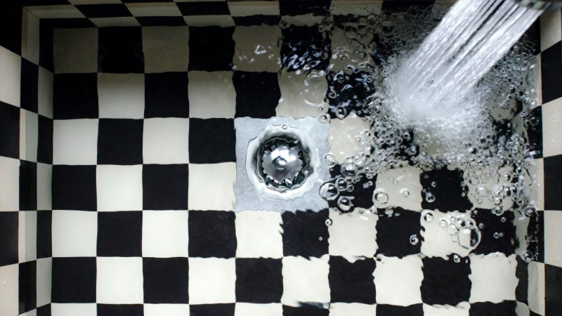 Top view of a checkered sink with water splashing, showcasing elegant design., tags: mit und - pexel