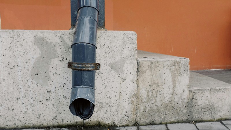 Close-up of an industrial concrete staircase and drainpipe in an urban setting., tags: frei - pexel